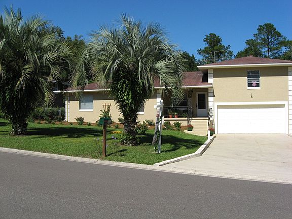 Mature palms line the front
