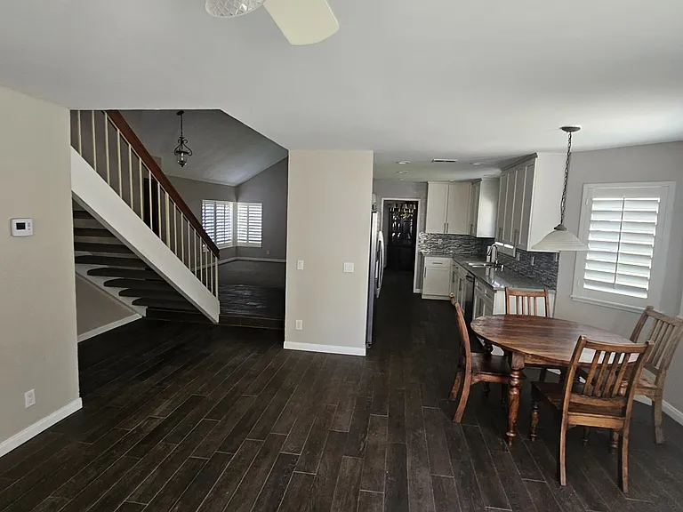 View from Family room into kitchen and Living room and stairs