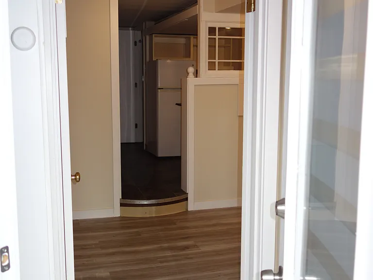 Looking from front door through living room and kitchen, bathroom in the back