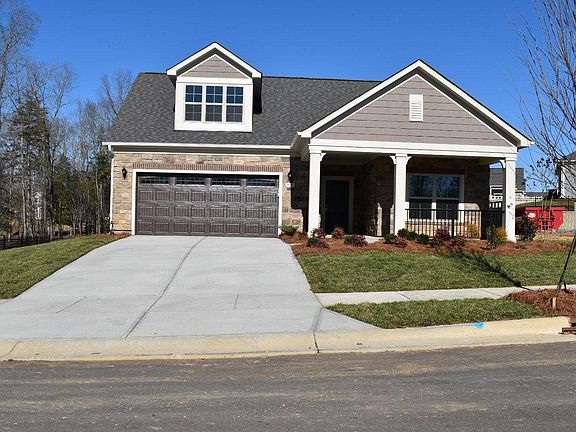 Rockers on the front porch, two car garage with storage area.