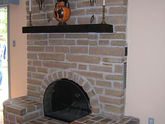 Family room features custom-built natural stone FP