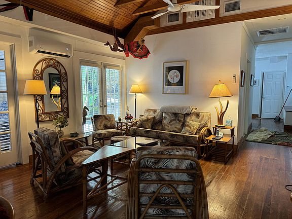 Key West style living room with vaulted ceilings
