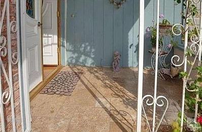 Travertine on elegant front porch.  Wrought iron gate for added safety for small children or pets.