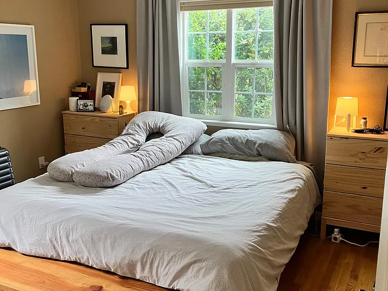 Bedroom shown with a king-size bed and two side tables; a dresser will also fit