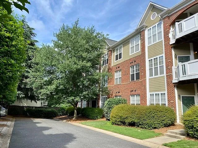 Unit is on the second floor at the end of this street, behind the tree on the right