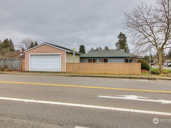 Large two car garage with workspace and storage.>