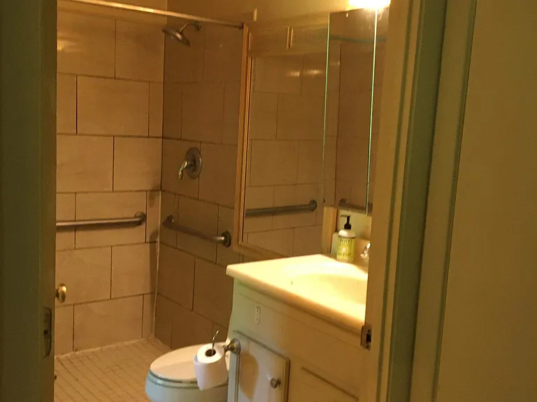 Bath features mirrored medicine cabinet, larger fashion mirror, walk in shower, entrance from bedroom 1 or study area