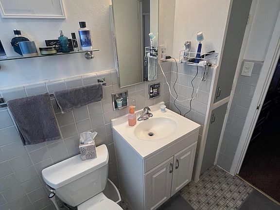 bathroom fixtures and built-in linen closet