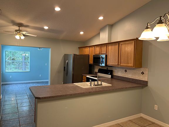kitchen and extra rear room viewing back yard