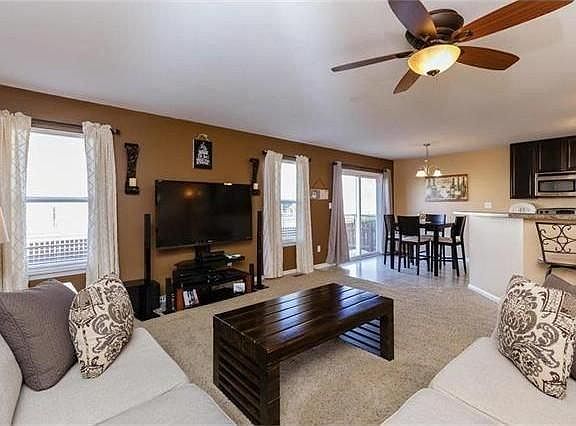 Spacious living area with open concept to kitchen; nice view