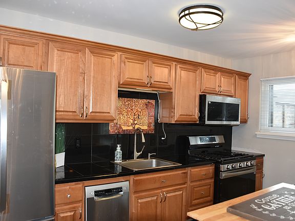 Beautiful updated kitchen with ALL new stainless appliances Refrigerator with ice maker, dishwasher, faucet, garbage disposal, gas range, microwave, and all new double paned windows.