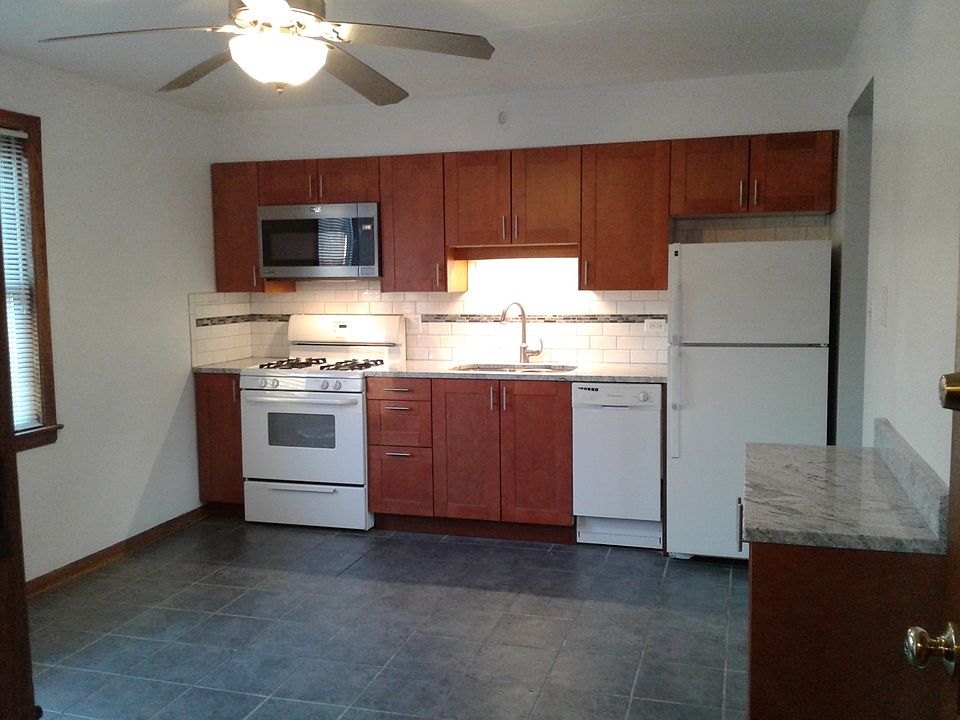 Large, eat-in kitchen includes stove, microwave, dishwasher, and refrigerator.