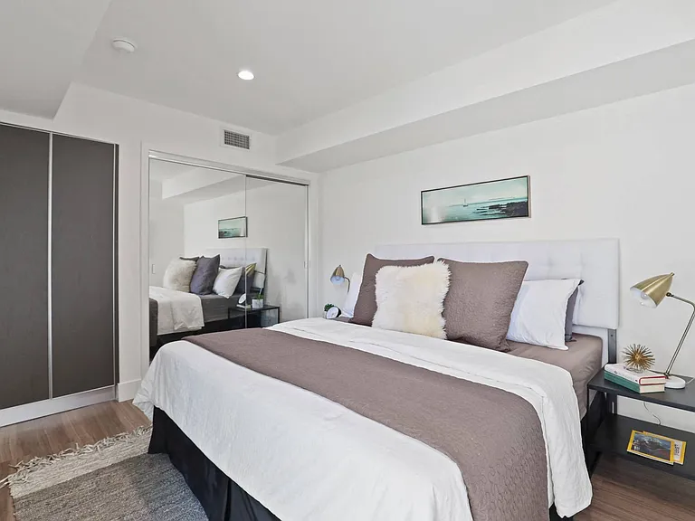 Bedrooms with Large Mirrored Closet Space and Additional Cabinet Storage