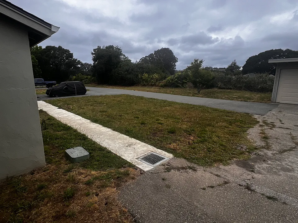 Open parking next to unit B and sidewalk to laundry room