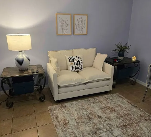 Private living room with a comfortable sofa, offering a relaxing space to enjoy your favorite shows, read, relax, or spend time with visiting friends and family.