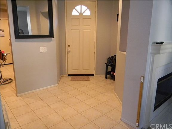 Spacious entry way, with neutral color tile which goes through entry way, through kitchen and breakf