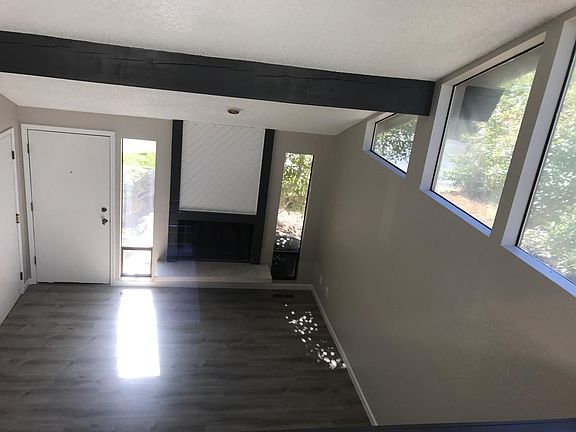 Spacious living room with fire place and vaulted ceilings wi