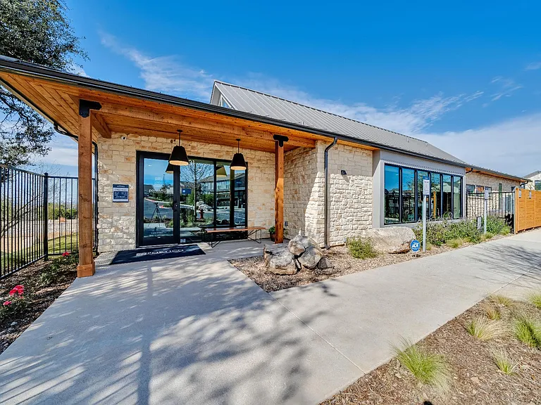 A modern building with a wooden roof and stone walls.