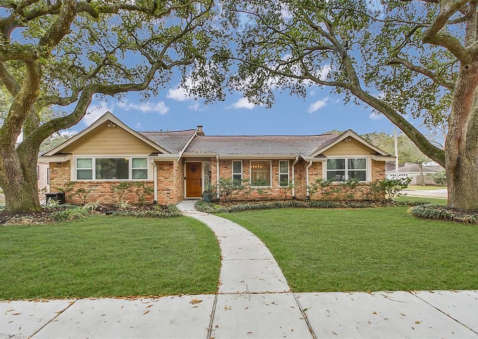 Welcome home to 6119 Cheena Dr. Fabulous curb appeal with mature trees. (lawn enhanced for photo)