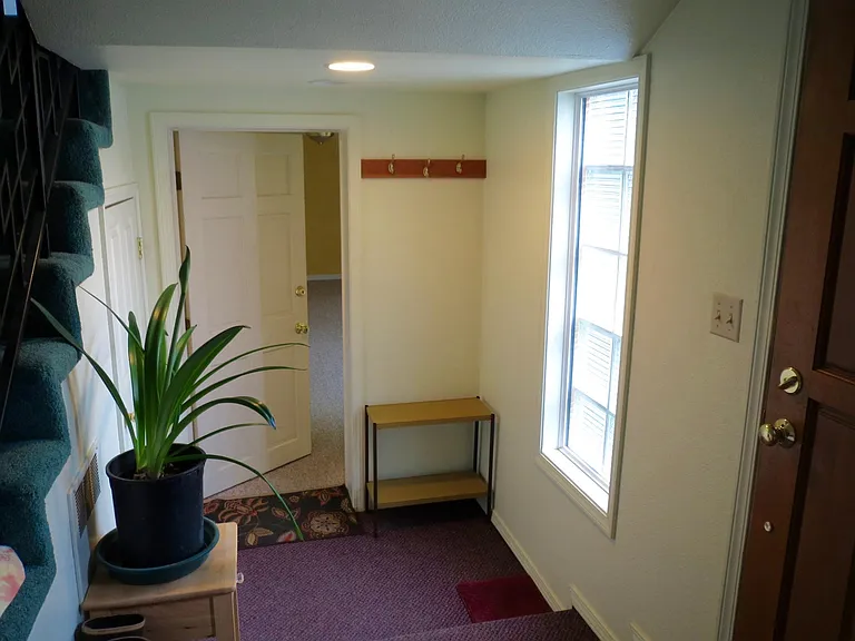 Shared entryway with upstairs unit. Additional storage area to left of door