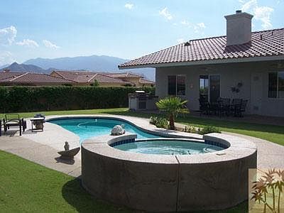 Pool and spa in backyard.