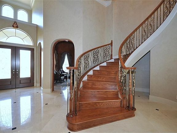Stunning entry w/high ceilings, spiral staircase,marble floors w.granite inlays!