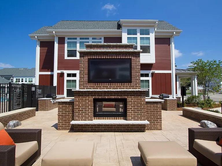 Outdoor lounge with fireplace and flatscreen TV