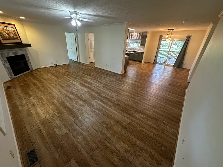 Living room standing at the front door. open concept living room with eat in kitchen.