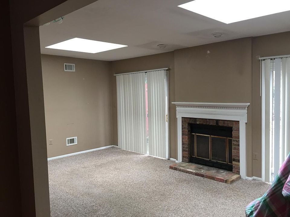 Family Room with fireplace and 2 sky lights, double slider doors to rear patio