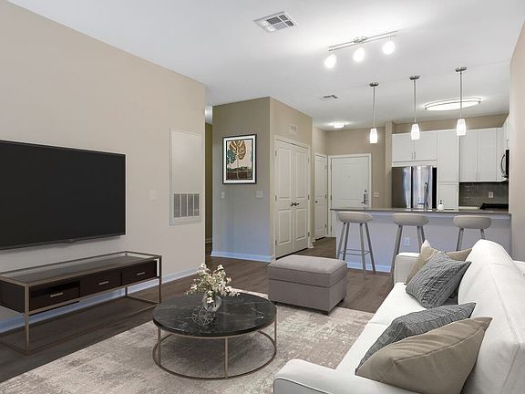 Renovated Package II kitchen, dining, and living areas with hard surface flooring