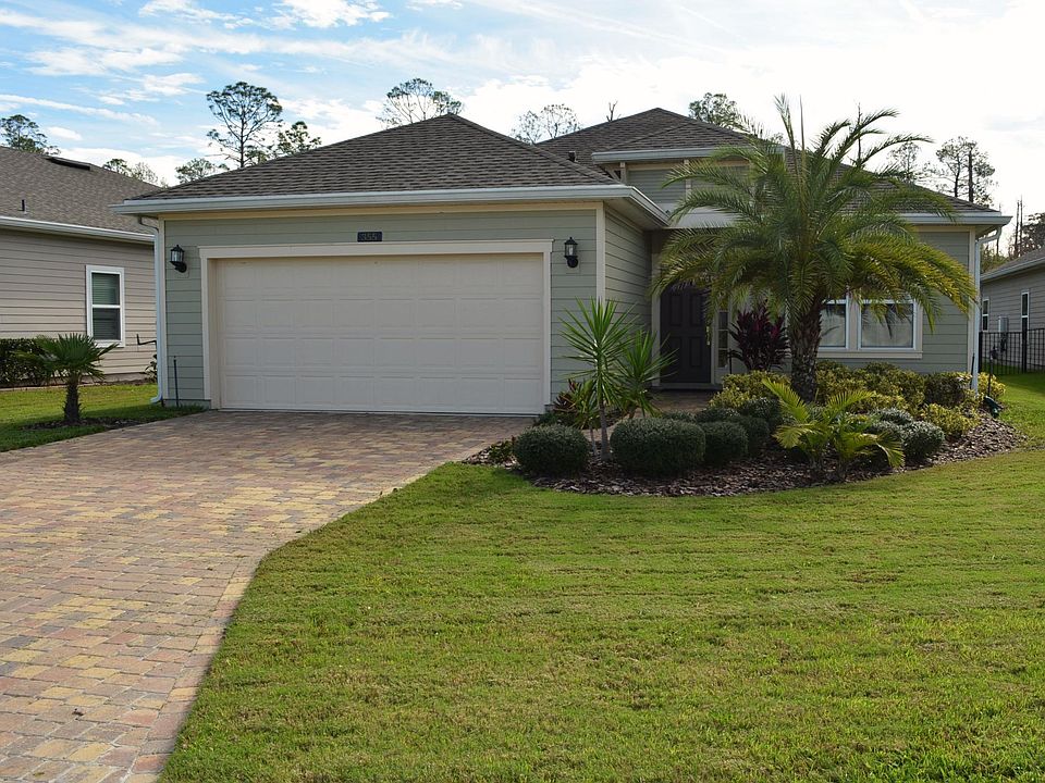 Brick paver driveway leading to 2 car garage with auto-garage door opener. Lawn sprinkler system.
