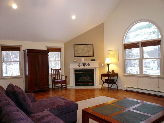 Sunwashed 23'x24' family room with hardwood floors & gas fireplace
