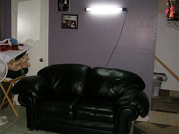 Living room with entry to stairs.