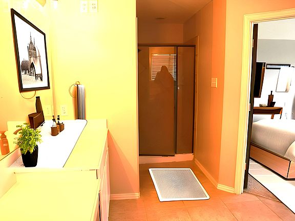 master bathroom inside master bedroom with standup shower and double vanity