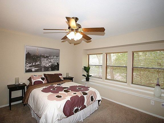 Spacious master bedroom with wall of windows.