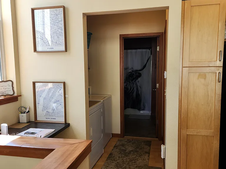 hallway from livingroom/kitchen to laundry, full bath, and bedroom.