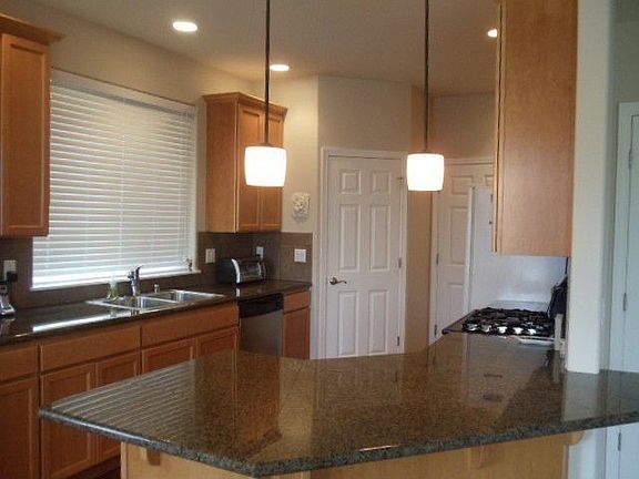 Kitchen with granite countertops, dual fuel range and walk in pantry.