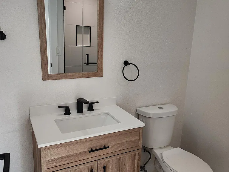 Guest bathroom with custom tiled shower