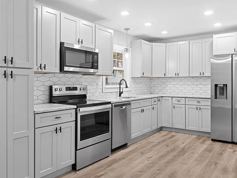 Beautiful, brand-new kitchen with updated appliances, cabinets, granite, large farmhouse sink, and fun backsplash