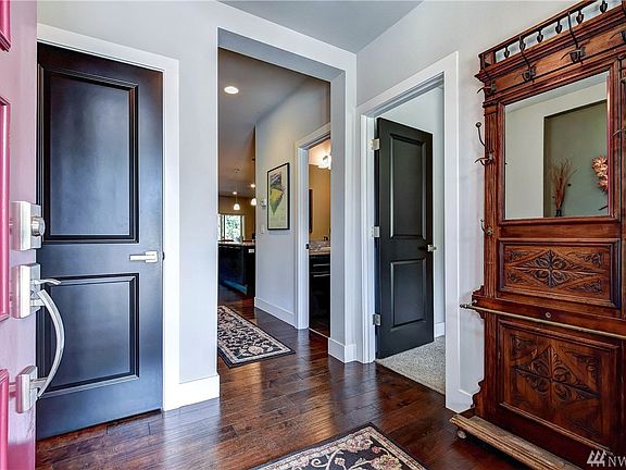 Rich, espresso hardwoods throughout the main level complement the chic black doors throughout
