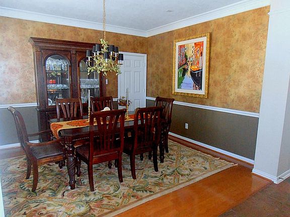 Formal dining with wood floors and custom wallcoverings.  Your friends and family will enjoy their meals in this area.