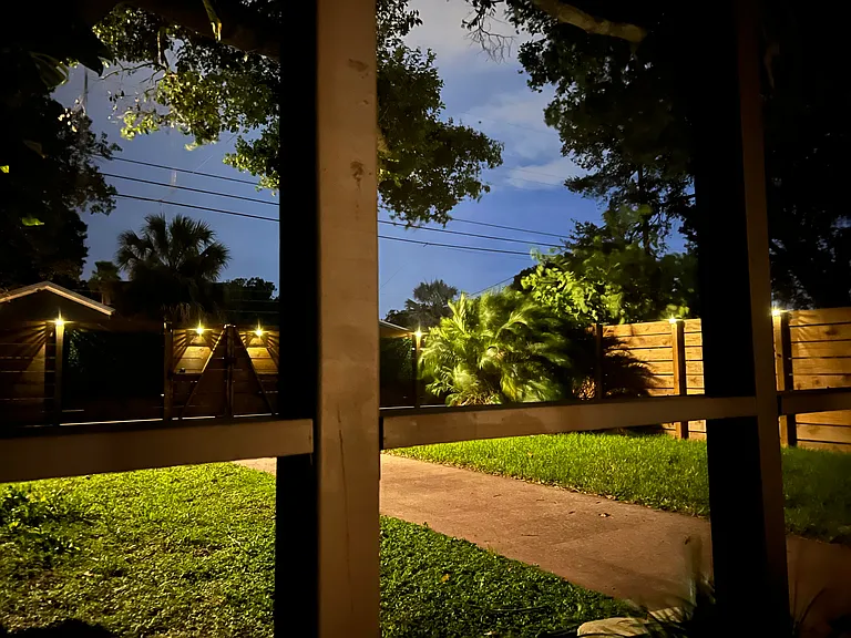 View from large screen porch into backyard
