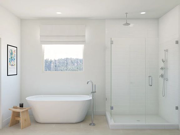 Primary bath with freestanding vanity and glass shower enclosure