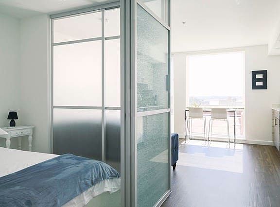 Private bedroom separated by frosted glass panels