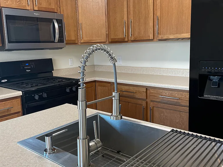 New large modern sink and faucet. Updated cabinets and new built-in microwave