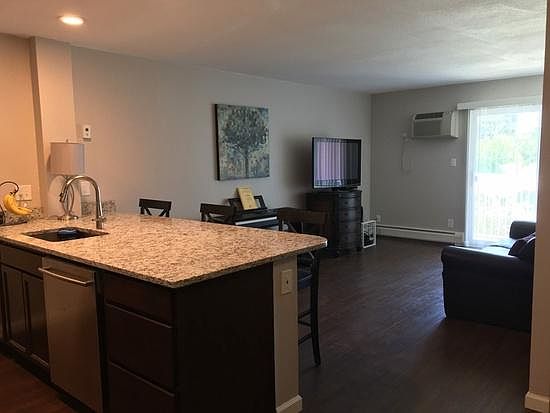 View of living room. Sliding glass door leads to balconey overlooking the pond.