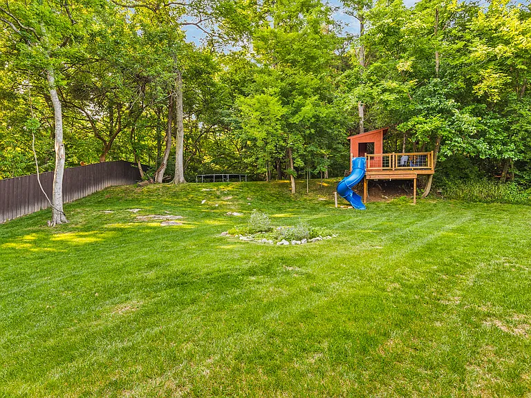 Huge backyard with a trampoline and a treehouse!