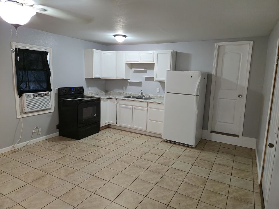 KITCHEN INCLUDES A FRIDGE AND A STOVE