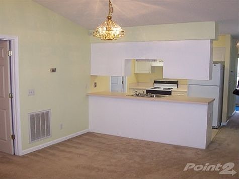 Open living, carpet and lots of windows