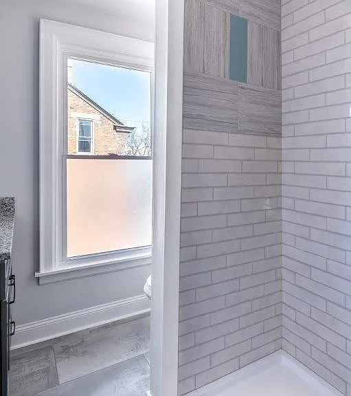 This shower has since had a glass door installed. Shown in a later photo.